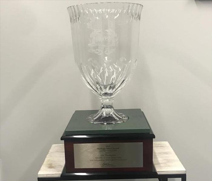 A photograph of an award with the inscription, "2019 Heritage Silver Award, SERVPRO Industries honors Eric Thompson..."