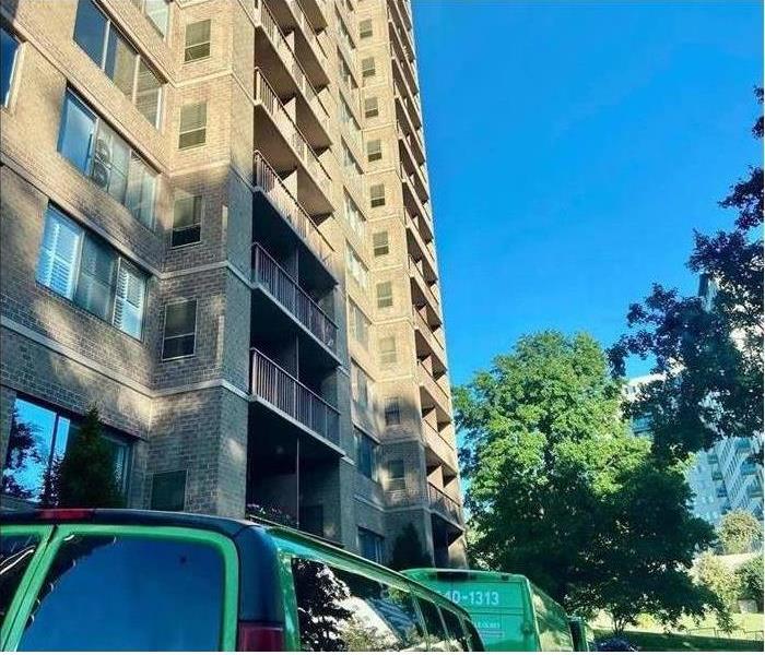 Green SERVPRO truck in front of building