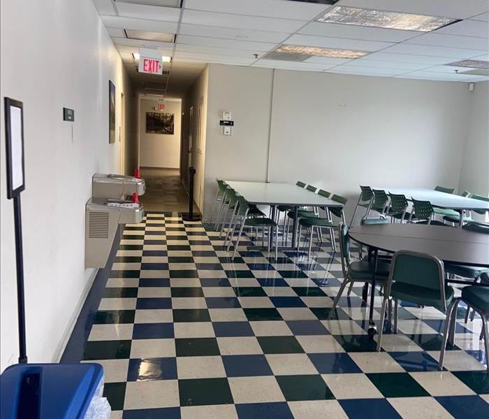 school cafeteria with tables and black white tile floor