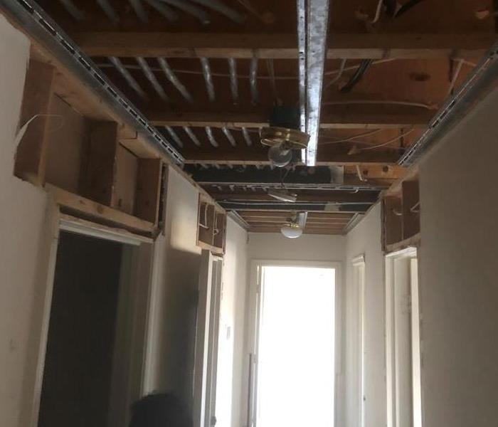 A hallway and ceiling damaged by water